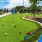 a putting green with putters and golf balls