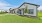 a house with a driveway and green lawn