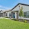 a house with a driveway and green lawn