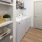 a room with white cabinets and a washer and dryer