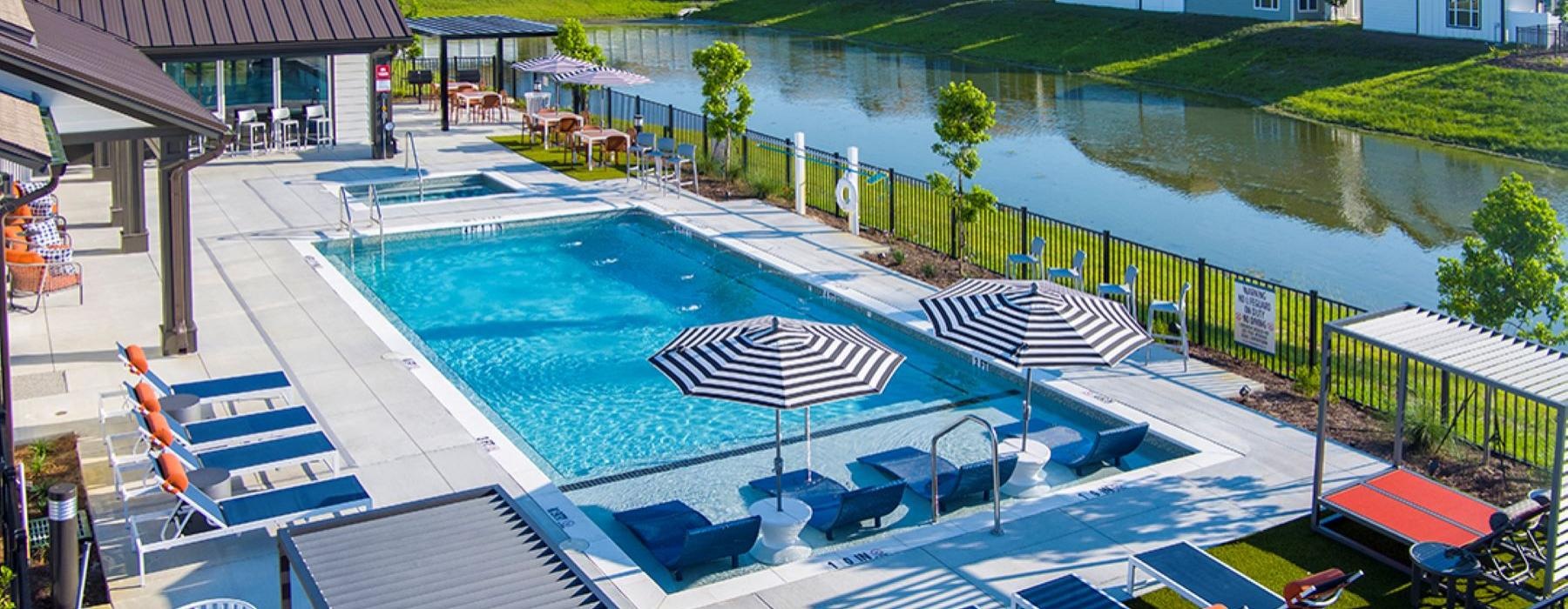 a swimming pool with lounge chairs