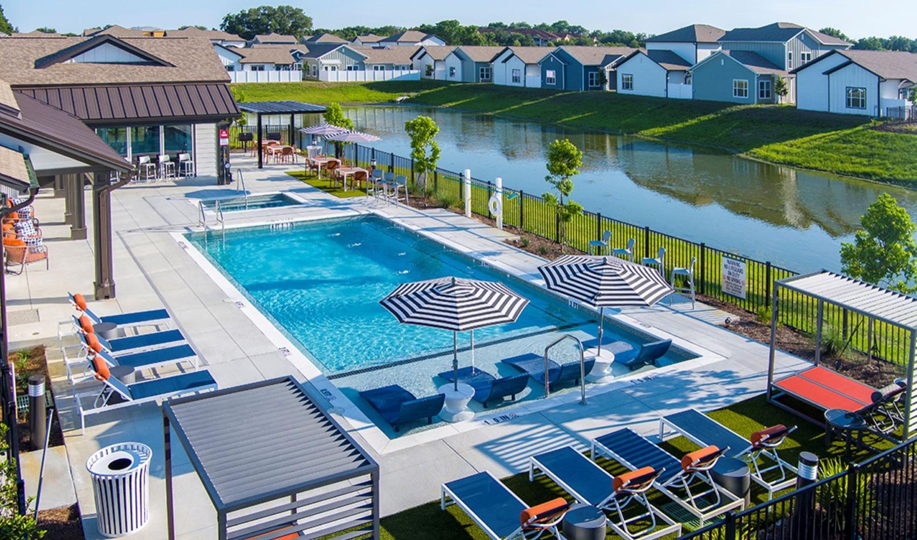 Relax and unwind poolside a swimming pool with lounge chairs