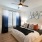 a bedroom with a bed and a fan