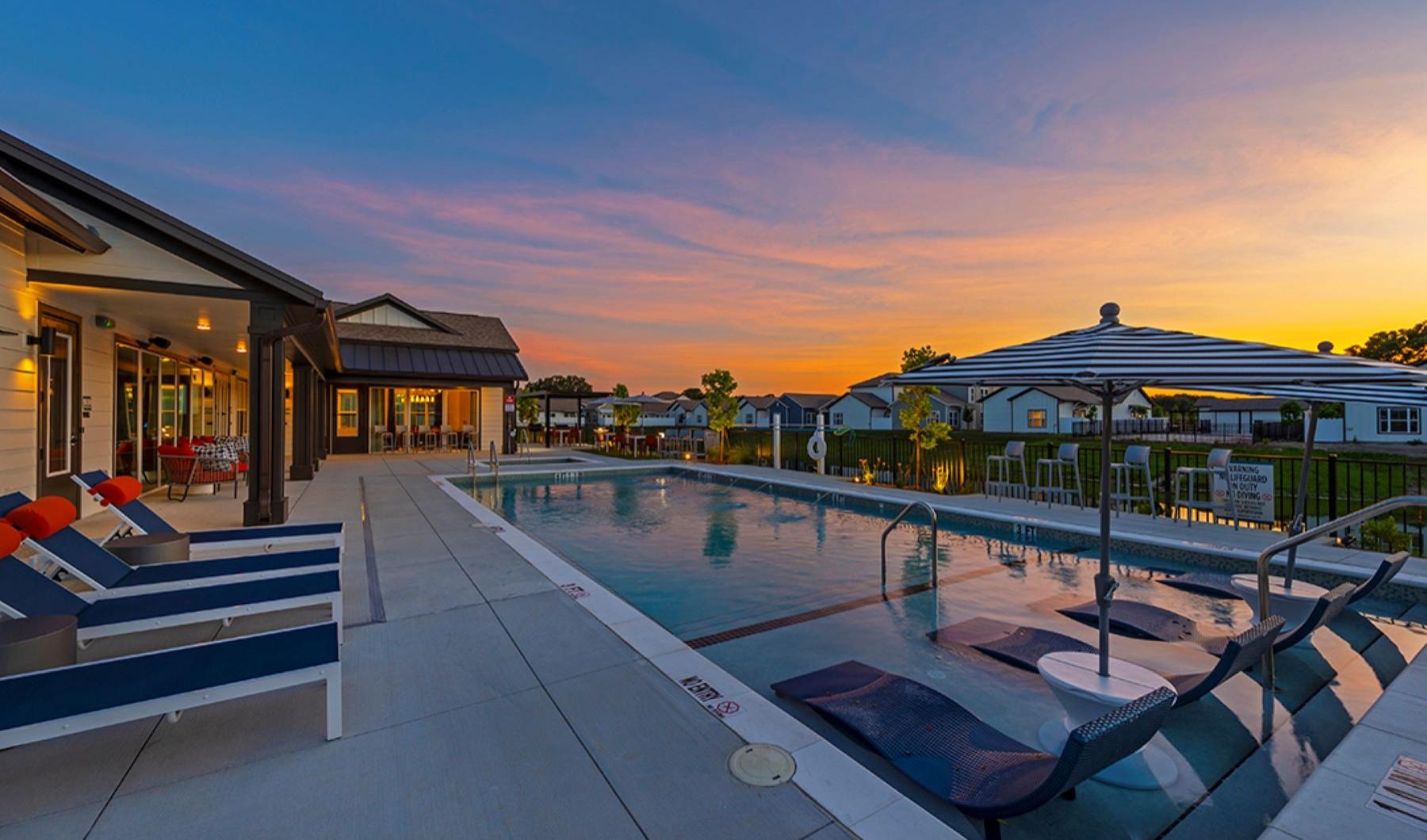 Sparkling swimming pool a swimming pool with lounge chairs at dusk